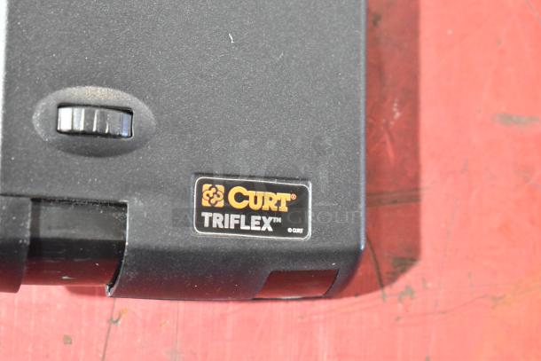 Curt Triflex brake controller, features logo and adjustment knob, in good condition.