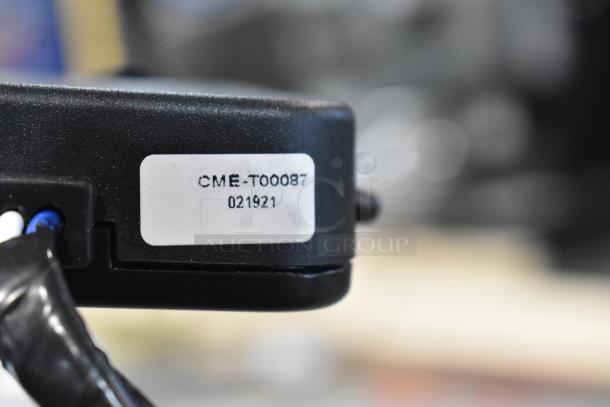 Close-up of item with a visible label reading "CME-T00087 021921." Part of a lot including GM 20844868 switch and Curt Triflex.