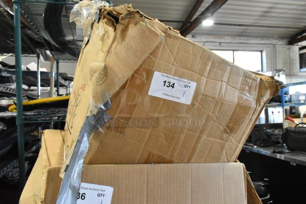 Damaged cardboard box of parts, including filter. Visible label indicates item number 134 for auction. Box taped and worn.