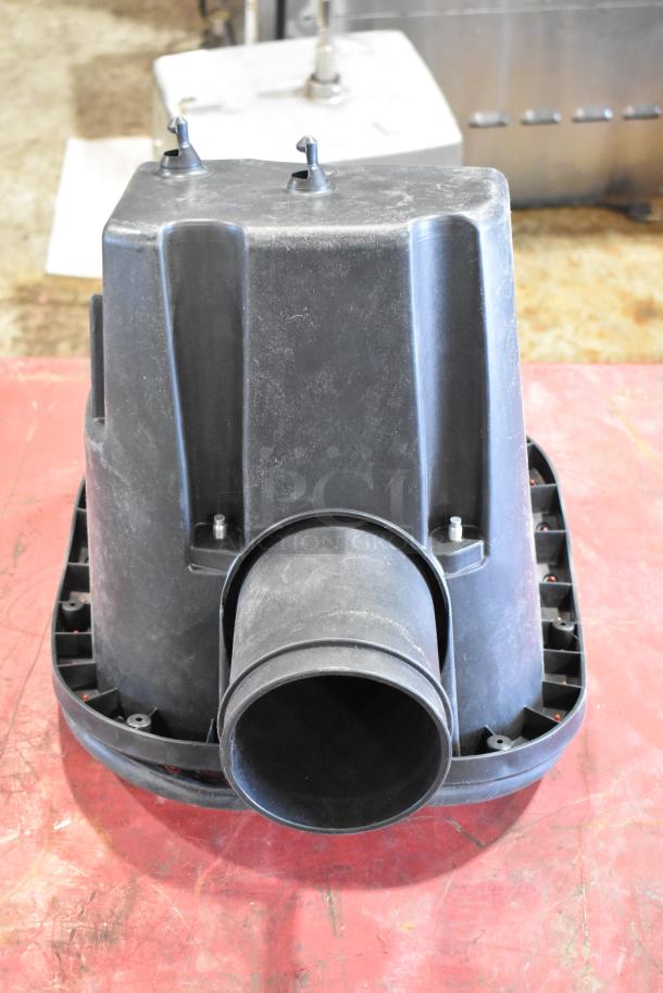 Box of assorted parts featuring a large black plastic filter housing, showing minor wear; includes attachment fittings.