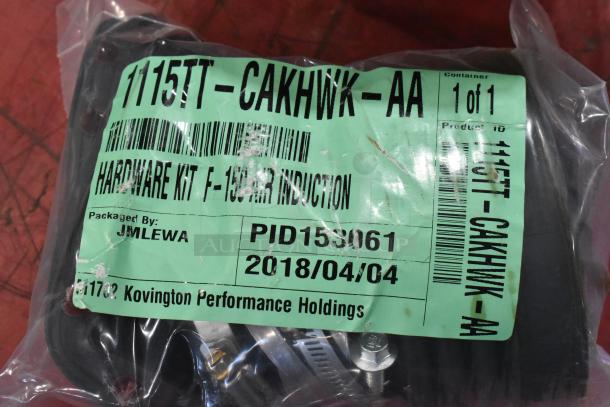 Box of parts including a filter, labeled for F-150 air induction. Tag reads "1115TT-CAKHWK-AA," packed by JM Lewa, dated 2018/04/04.