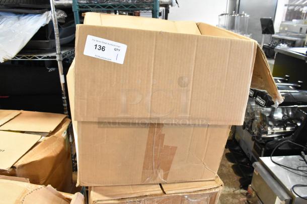 Cardboard box labeled "136 QTY" containing parts including a filter. Box is worn, indicating used condition.