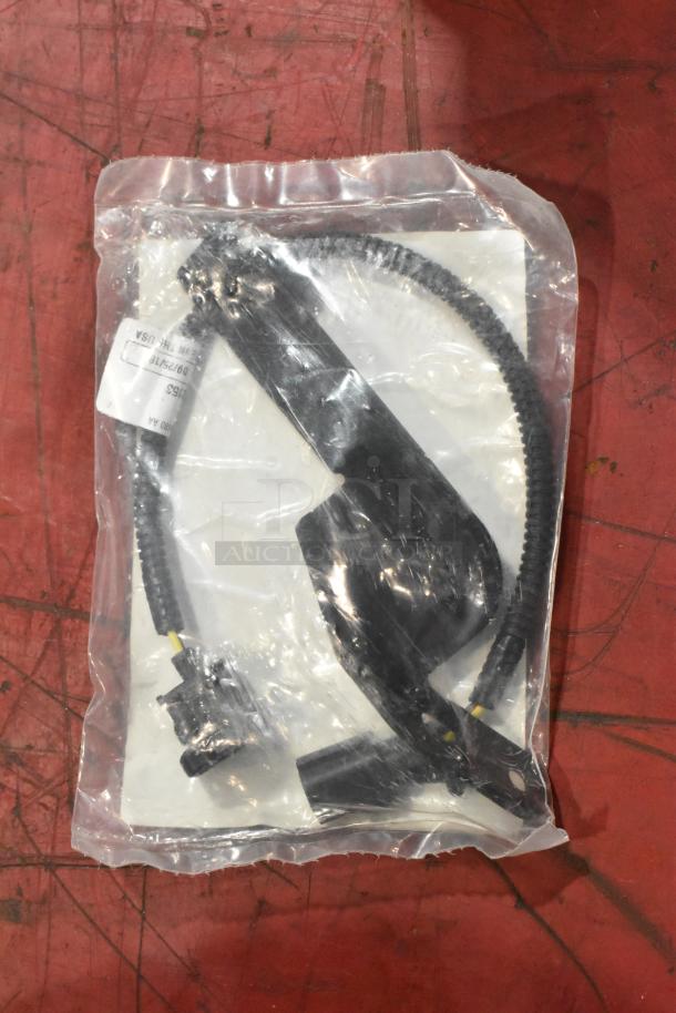 Bag containing parts including a filter, sealed in clear packaging. Label details obscured, components appear unused.