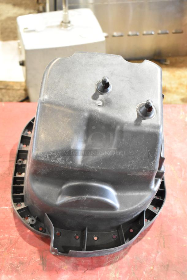 Box of Parts Including Filter, showing a large black plastic component, possibly a filter housing, in used condition.