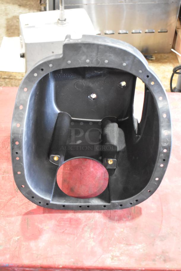 Box containing plastic part with circular opening and drilled holes, condition appears used; details unspecified.