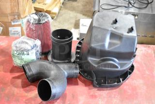 Box of parts with 1115TT-CAKHWKB-AA cold air intake kit, new condition, includes filter and intake components.