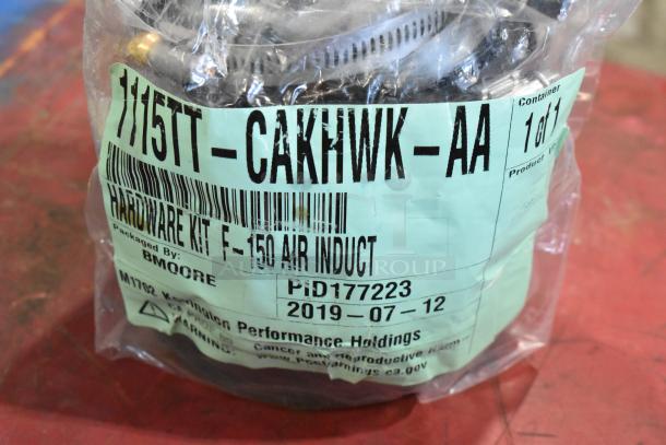 Box of parts including 1115TT-CAKHWKB-AA cold air intake kit, labeled for F-150 air induction. Packaged by BMOORE.