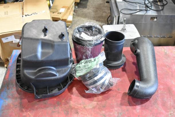 Box of parts with 111550-CAKHWX-AA cold air intake kit. Includes filter, hoses, and components. New in packaging.