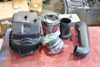 Box of parts with 111550-CAKHWX-AA cold air intake kit. Includes filter, hoses, and components. New in packaging.