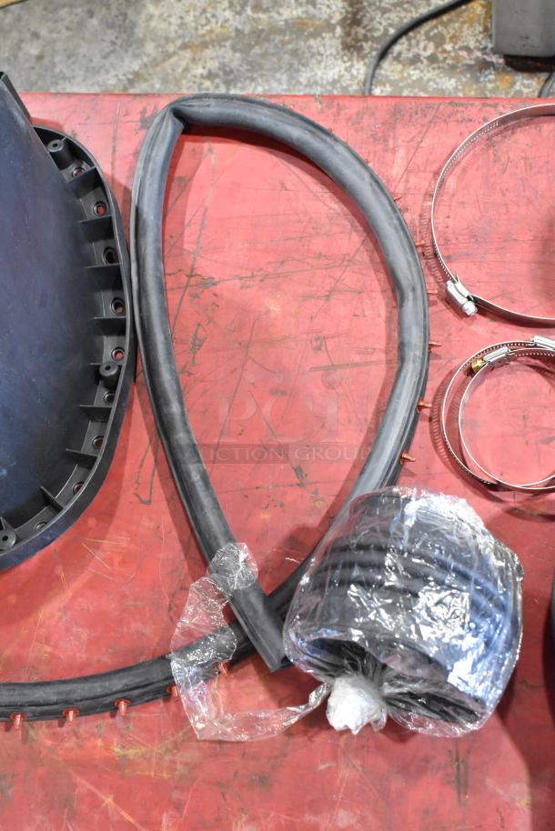 Box of parts including a cold air intake kit with hoses, clamps, and a duct piece. Items appear new and packed in plastic.