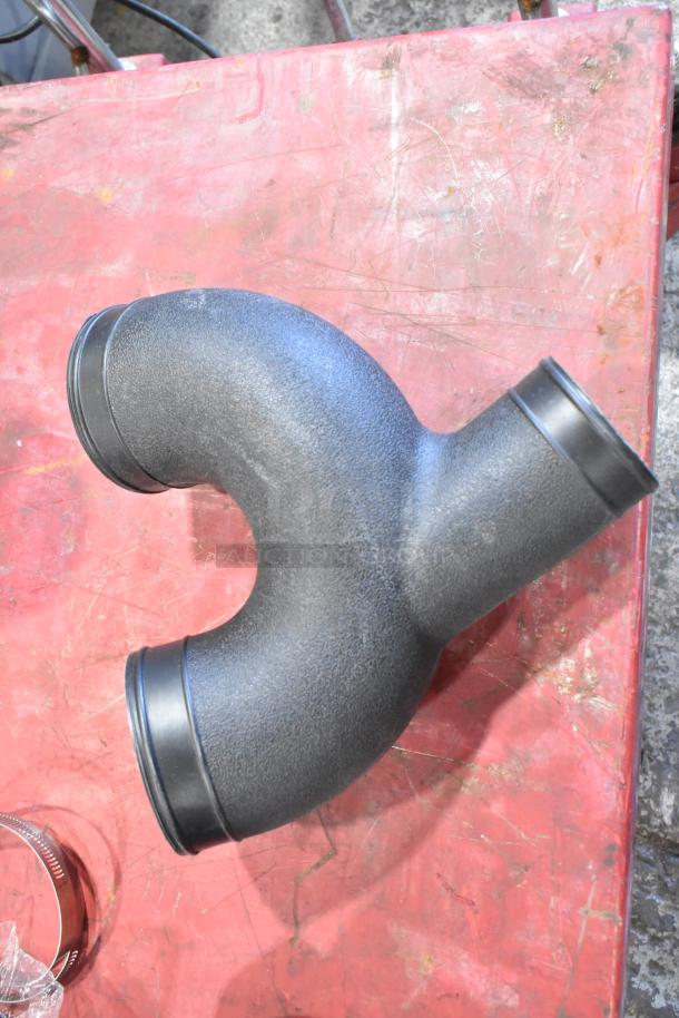 Box of car parts featuring a black cold air intake kit component, new condition, rubber and plastic material.