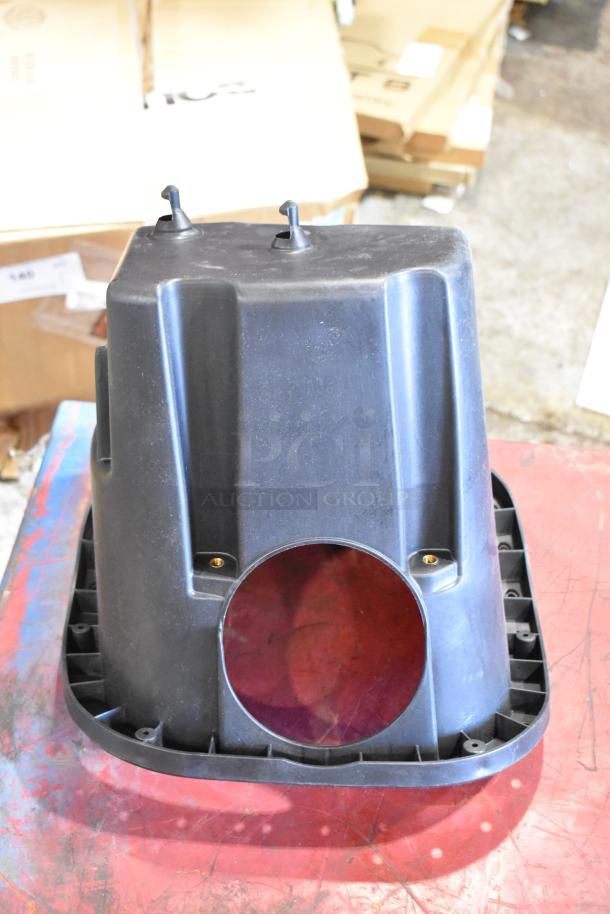Box of parts featuring a cold air intake kit component, black plastic, visible mounting points, in used condition.