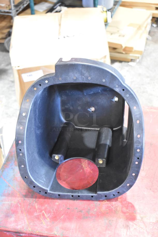Box of parts featuring a cold air intake kit component. Black plastic with a circular opening and bolt holes. Good condition.