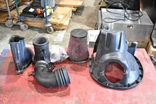Box of auto parts including 131550-CAKHK-AB cold air intake kit with filter and hoses, in used condition.