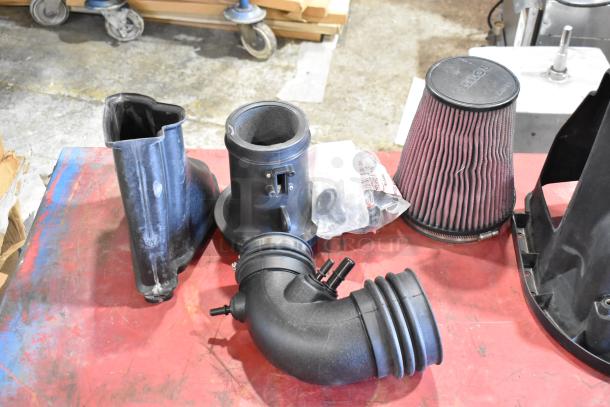 Box of parts featuring 131550-CAKHK-AB cold air intake kit, includes hoses, air filter, and fittings, in used condition.