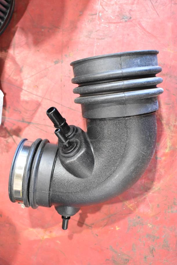 Box of parts featuring black 131550-CAKHK-AB cold air intake kit in excellent condition on red background.