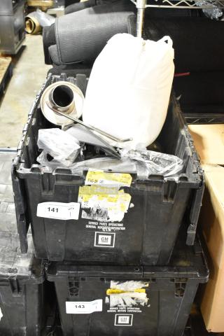 Box of assorted parts in a black GM poly bin with exhaust components and labels detailing service parts operations.