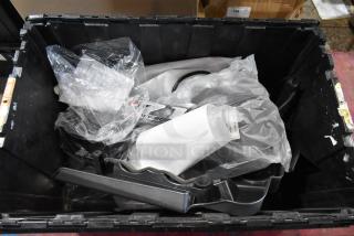 Box of assorted parts including a headrest in a black poly bin, various components wrapped in plastic, item code PB60025S visible.