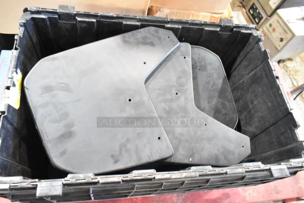 Box of GMC panels in black poly bin, panels have pre-drilled holes, used condition, suitable for parts replacement.