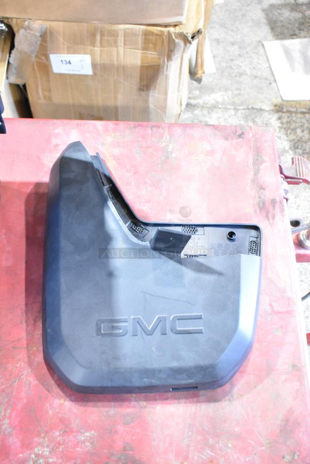 Box of parts including GMC panels, featured in a black poly bin. Panels embossed with "GMC" logo, in good condition.