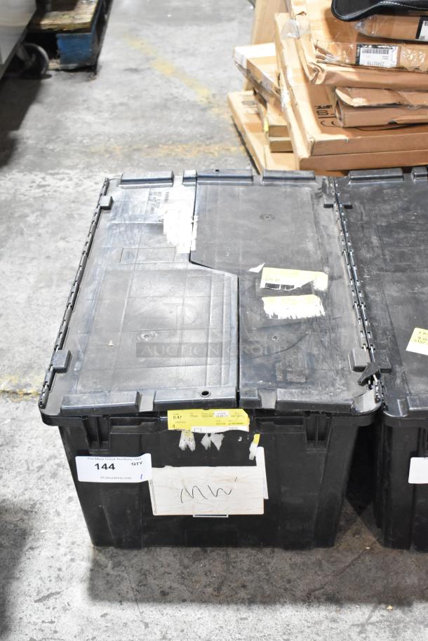 Black poly bin with GMC panels, marked with labels and lot number 144, indicating contents and auction information.