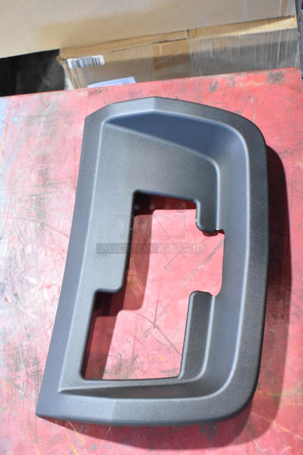 Box of GMC panels in black poly bin, featuring a black plastic panel piece, good condition.