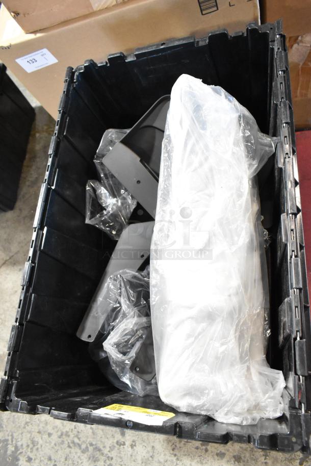 Box of GMC panels in a black poly bin, includes parts in protective plastic wrapping, appears in good condition.