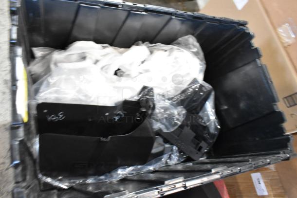 Box of parts including GMC panels in a black poly bin, wrapped in plastic. Panels show markings and are in good condition.