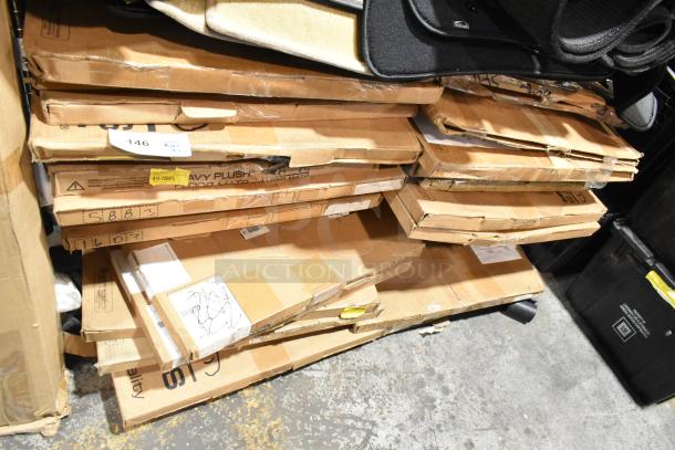Boxes containing 27 brand new scratch and dent Jeep Wrangler, Yukon Denali, and Corvette C7 floor mats stacked. Some labels visible.
