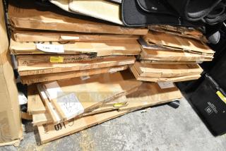 Boxes containing 27 brand new scratch and dent Jeep Wrangler, Yukon Denali, and Corvette C7 floor mats stacked. Some labels visible.