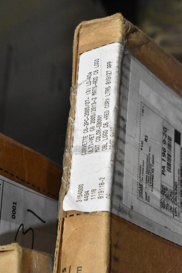 Box with a label for Corvette C6 floor mats, mentions "logo C6" and "Red Corn." Item part of a 27-piece scratch and dent lot.