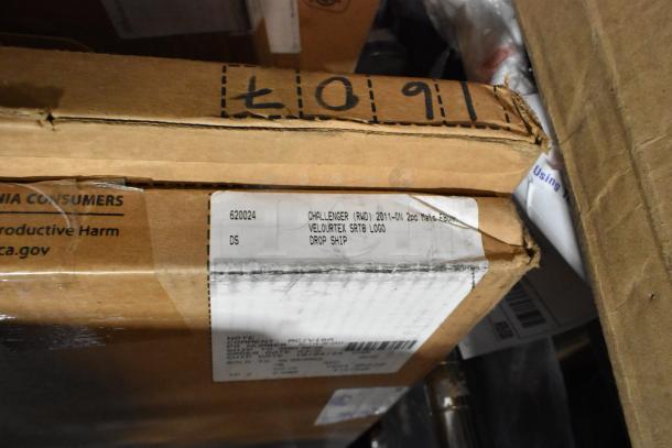 Cardboard box with label "Challenger (RWD) 2011-ON 2pc Mats Velourtex SRT8 Logo." Part of a 27 item scratch-and-dent auction lot.
