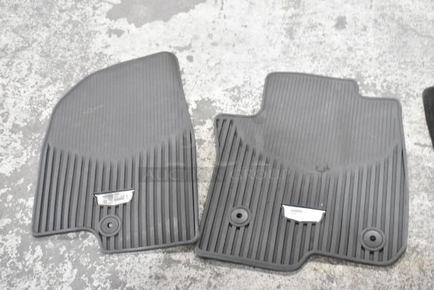 22 various car floor mats, black rubber, ribbed texture, Cadillac logo on tags, good condition, bulk auction lot.