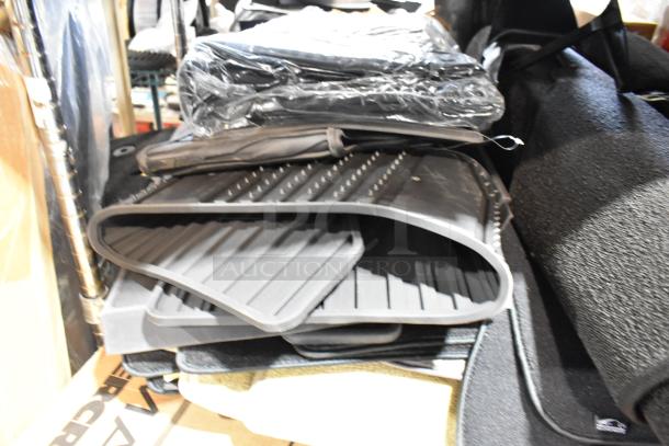 Set of 22 various car floor mats, new condition, assorted textures and styles, stacked for auction, increase bid value.