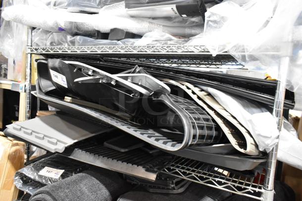 Stack of 24 various car floor mats on metal shelving, in assorted designs and colors. Auction tag visible.