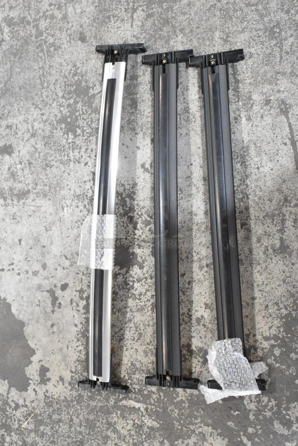 Set of three black and silver rails with attached bubble wrap on a concrete surface. Bundle of 10 various items.