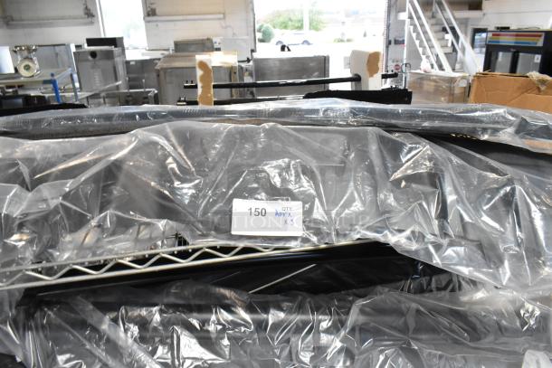 Plastic-covered car floor mat, lot tag "150 APX X3". Warehouse setting, items appear in unused condition.