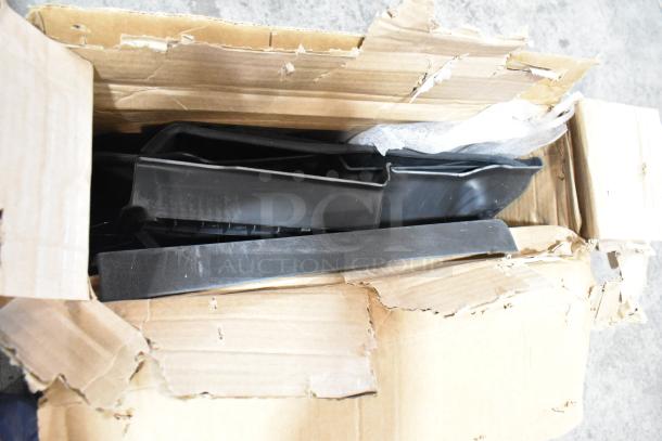 Box of car floor mats, black, unopened but in a damaged cardboard box, suitable for various vehicle models.