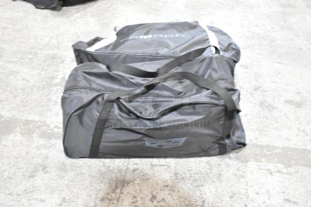 ALL ONE MONEY! Mixed lot with hubcap, panels, and black bags. Features Camaro branding, Cadillac logo. Good condition.