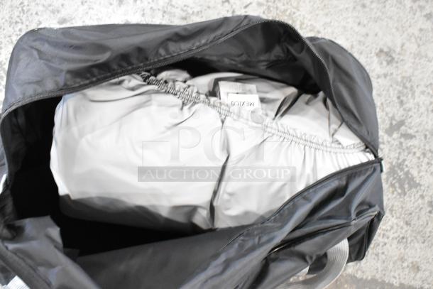 Open black bag containing gray fabric, showing a partially visible label marked "Mexico."