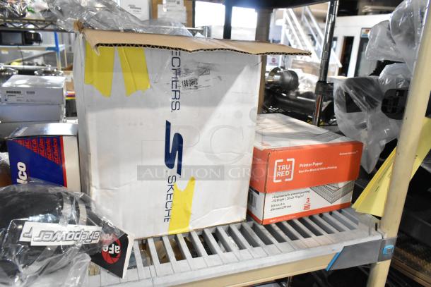 Tiered auction lot including Tru Red printer paper, Skechers box, ACDelco car filter, and other items on shelving.