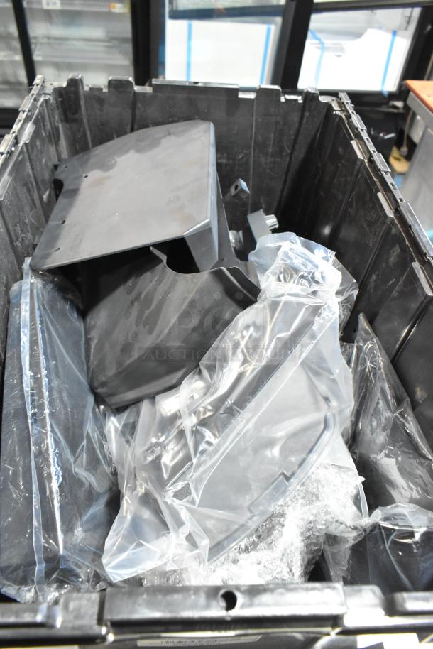 Lot of various GMC parts in a black poly bin, includes plastic-wrapped components, assorted condition.