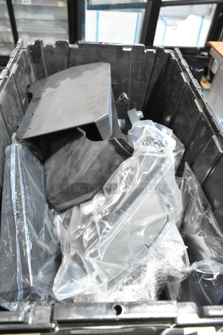 Lot of various GMC parts in a black poly bin, includes plastic-wrapped components, assorted condition.