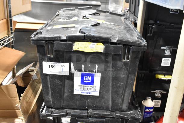 Black poly bin with various items, including Chevy panels. Contains GM label and auction tag with number 159.