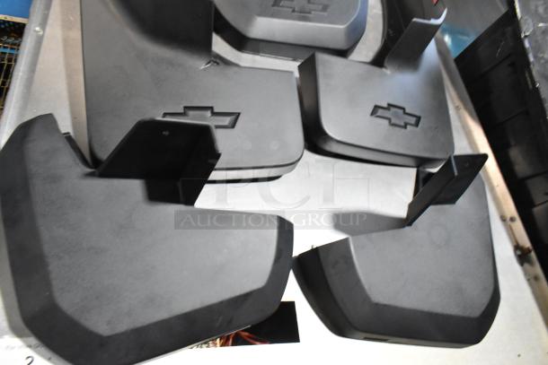 Lot of Chevy panels in black poly bin, featuring embossed Chevy logos, in good condition. Includes multiple panels.