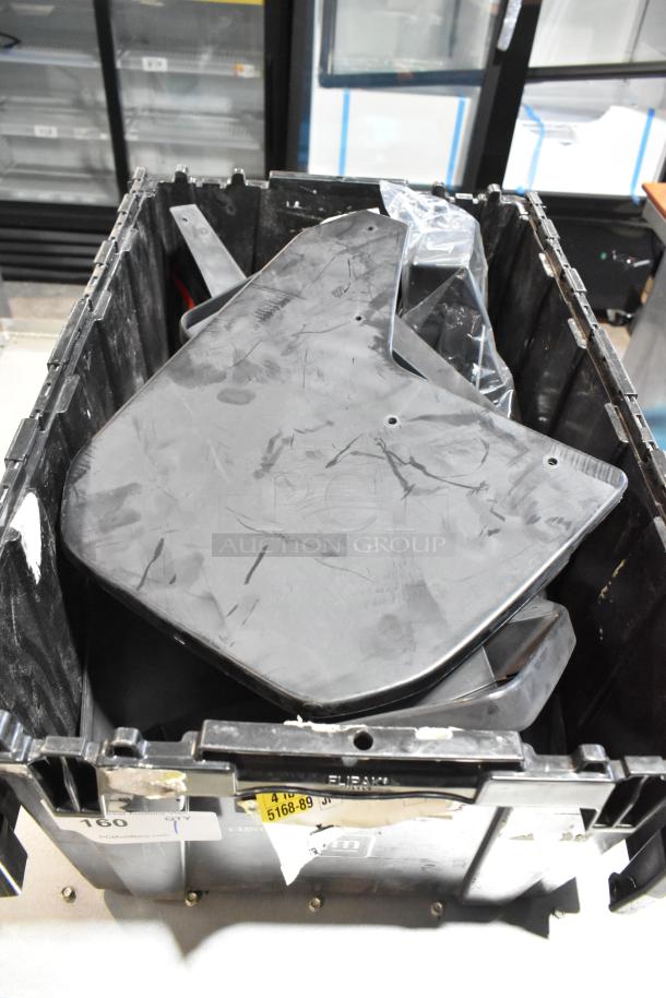 Lot of various items including GMC panels in a black poly bin. Panels show surface wear. Labels and markings visible on the bin.