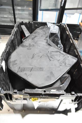 Lot of various items including GMC panels in a black poly bin. Panels show surface wear. Labels and markings visible on the bin.