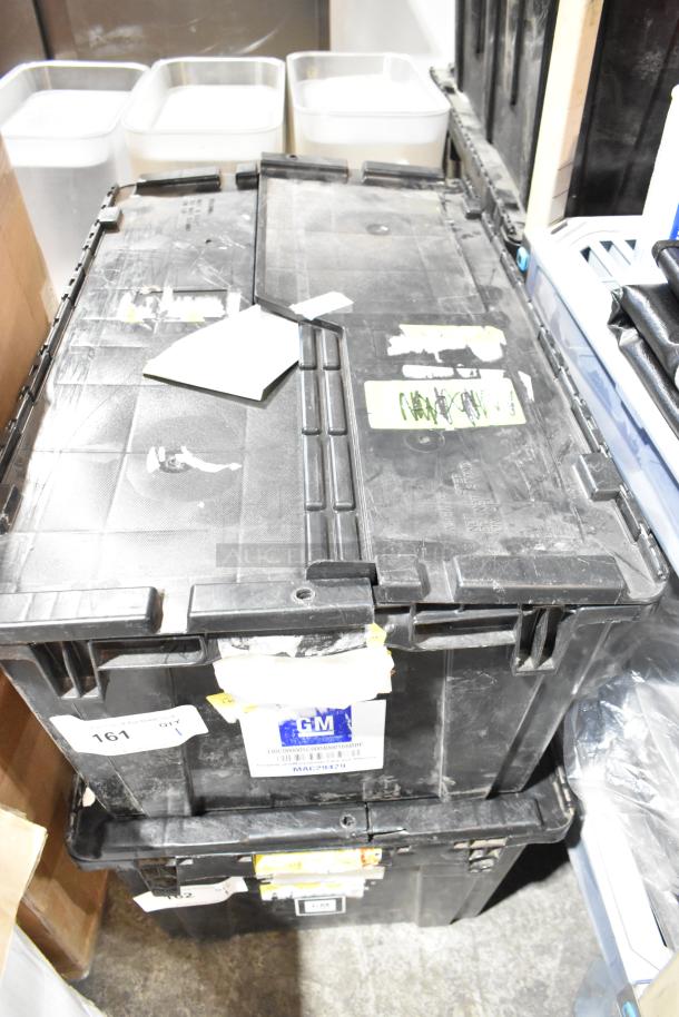 Black poly bin containing various items, including GMC panels. Labels and markings visible, indicating inventory details.