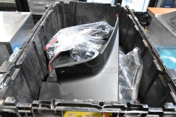 Black poly bin containing various items, including GMC panels, visible in plastic bags, in good condition.