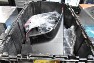 Black poly bin containing various items, including GMC panels, visible in plastic bags, in good condition.